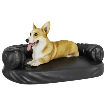 Ein entspannter Corgi liegt auf einem schwarzen, gepolsterten Haustierbett mit erhöhten Seiten, das Komfort und Stil zeigt.