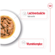 Eine Schüssel mit Haustierfutter, die Stücke von Fleisch in Soße zeigt, mit Text, der "Leichtverdauliche Nährstoffe" und "Vitamincomplex" hervorhebt.