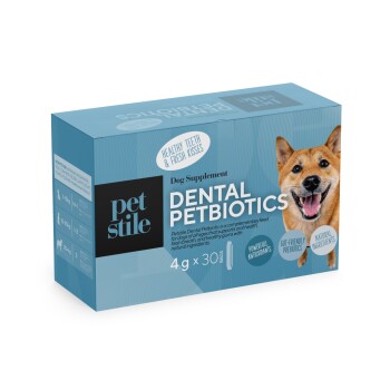 Blaue Schachtel des Pet Stile Dental Petbiotics Hundesupplements mit einem lächelnden Hund und Text, der gesunde Zähne und frische Küsse hervorhebt.