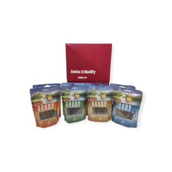 Quatre sacs de friandises semi-humides pour chiens "Goody" dans différentes saveurs devant une boîte rouge "Swiss Quality" avec delipet.ch.