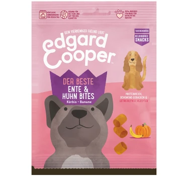 Verpackung von Hundeleckerlis mit einem Cartoon-Hund und einem Golden Retriever, beschriftet mit "Edgard Cooper Der Beste Ente & Huhn Bites" mit Kürbis und Banane.