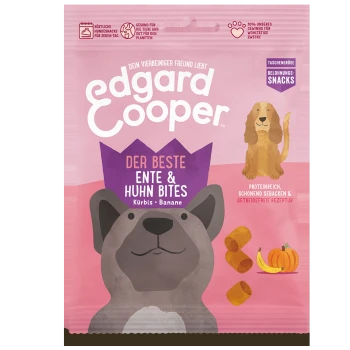 Verpackung von Hundeleckerlis mit einem Cartoon-Hund und einem Golden Retriever, beschriftet mit "Edgard Cooper Der Beste Ente & Huhn Bites" mit Kürbis und Banane.