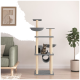 Ein stilvoller Katzenbaum mit Ebenen und Kratzpfosten, mit einer getigerten Katze auf einer Plattform, in der Nähe eines grünen Sofas und einer Topfpflanze.