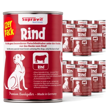 Rot-weiße Dosen von Supravit Rind Premium-Hundefutter mit Hund- und Kuh-Illustration, deutschem und englischem Text.