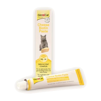GimCat Cheese Biotin Paste Tube und Schachtel, gelb/weißes Verpackungsdesign mit grauer Katze, Käsestück und Text Haut- & Fell-Komplex.