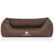 Braunes Hundebett mit modernem Design, mit einer erhöhten Rückenlehne und dem Logo "KNUFFELWUFF" deutlich sichtbar.