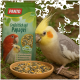 Ein Nymphensittich mit einer gelben Haube frisst Samen aus einer Schüssel neben einem grünen Beutel mit der Aufschrift "PANTO" und Papageienbildern sowie Vitaminansprüchen.