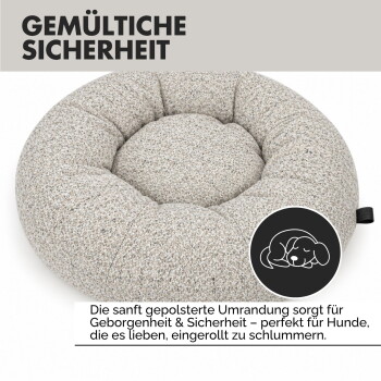 Rundes, plüschiges Haustierbett in einem hellbeigen Farbton mit einem gepolsterten Design, das ein kleines "Paw Wow"-Etikett an der Seite hat.