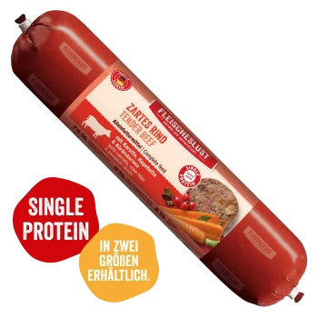 Fleischeslust Futterbox – Holzkiste mit Hundefoto, dem Text „Natürlich & Artgerecht“ und einer roten Rolle mit der Beschriftung „Zartes Rind (Tender Beef)“.