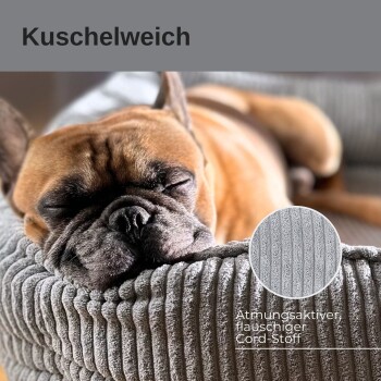 Ein schlafender Französischer Bulldogge auf einem weichen, gerippten Haustierbett mit dem Text "Kuschelweich", der den Stoff als atmungsaktiv und flauschig beschreibt.