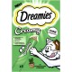 Dreamies Cremige Katzenleckerliverpackung mit einer verspielten Katze, die nach einer Tube greift, mit Text, der "Ohne Zuckerzusatz" und "Mit Taurin" hervorhebt.