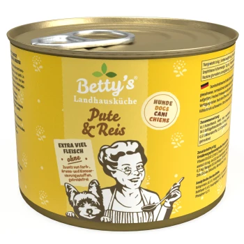 Eine Dose Betty's Landhausküche Hundefutter mit einem gelben Etikett mit dem Text "Pute & Reis" und einer Illustration einer Frau mit einem Hund.