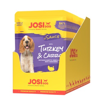 JosiDog Mini Adult Nassfutter für Hunde mit Pute und Karotte in Sauce, 84 % Fleisch und tierische Nebenerzeugnisse, gelbe und lila Verpackung.