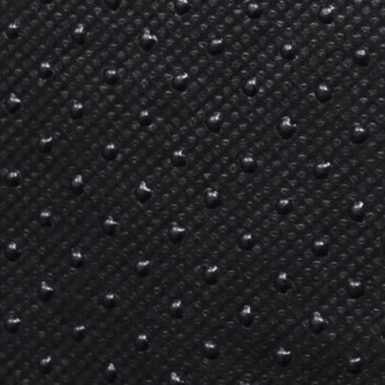 Nahaufnahme einer strukturierten schwarzen Oberfläche mit kleinen erhabenen Punkten, die einem Material für Haustierprodukte ähnelt.