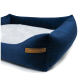Navy-blaues Haustierbett mit einem weichen grauen Zentrum und erhöhten Rändern, mit einem Lederetikett, das "RexProduct.com" liest.