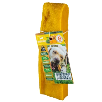 Gelbes Hundekauspielzeug mit einem Etikett, das einen Hund zeigt, der auf einem Leckerli kaut, gekennzeichnet mit "XL Größe" und "mit Kurkuma", was auf die Zugabe von Kurkuma hinweist.