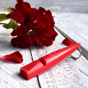 Rote ACME Pfeife mit schwarzem Halsband und Metallclip, beschriftet mit „BPA Free“ und „Made in England“.