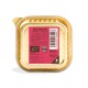 Gold pet food tray with pink label reading "BIGGER DOGS HAVE BIGGER APPETITES!", barcode, feeding guide and 100g.