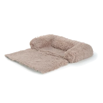 Un lit pour animaux de compagnie en peluche beige avec des côtés surélevés et une texture douce et shaggy, idéal pour les petits chiens ou chats.
