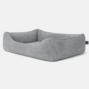 Hundebett ANTON Cord Grau M Graues gestreiftes Haustierbett mit erhöhten Rändern, das ein weiches Innenleben und ein kleines Etikett mit der Aufschrift 'PAW NOW' hat.