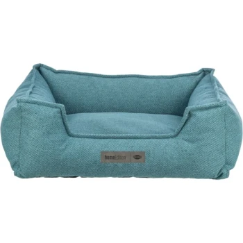 Ein gemütliches türkisfarbenes Haustierbett mit erhöhten Seiten und einem weichen Innenraum, mit einem kleinen Metallschild, auf dem "homeEdition" steht.