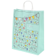 Eine hellblaue Geschenktüte, dekoriert mit bunten Ballons, Partykappen und Konfetti, mit dem Text "Nur für dich" in eleganter Schrift.