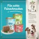 Dosen von Bettys Tiernahrung mit den Aufschriften "Mit Kanguru & Kartoffel", "Lamm & Reis" und "Fleisch pur" mit einem Teller mit Futter und einem Hund.