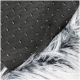 Close-up of a pet blanket featuring a textured black fabric with small dots and a fluffy white and black fur edge.
