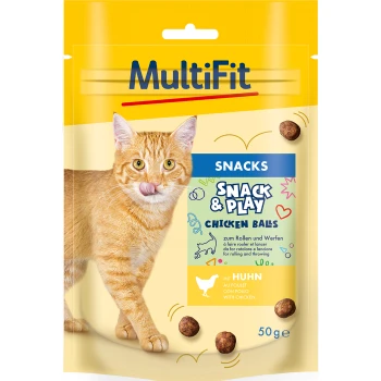 Orange tabby cat licking its lips next to a package of MultiFit Snack & Play Chicken Balls, featuring playful graphics and text.