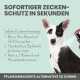 Ein schwarz-weißer Hund wird mit einem Zeckenschutzprodukt besprüht. Der Text enthält Anwendungshinweise und betont pflanzliche Inhaltsstoffe.