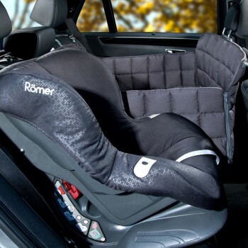 Autositzbezug für Haustiere, mit einem gepolsterten Design in Schwarz mit einem Romer-Logo, im Fahrzeug positioniert.
