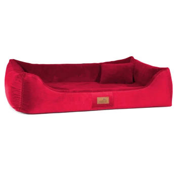 Rotes plüschiges Haustierbett mit erhöhten Rändern und einem kleinen Rückenkissen, mit einem beigen Etikett, das 'tierland' liest.