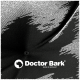 Schwarzes Haustierbett mit gepolstertem Design, mit einem grünen "Doctor Bark"-Label auf einer Seite.