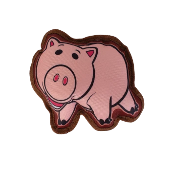 Pink pig-shaped plush pet toy with brown border and cartoon face on black background