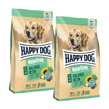 Zwei Beutel Happy Dog NaturCroq Balance Adult Hundefutter mit einem Bild eines Golden Retrievers und einer Sonnenblumengrafik.