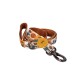 Orange-lined pet leash with cowboy dog pattern, metal clasp and yellow round tag; ribbon shows small cursive text.