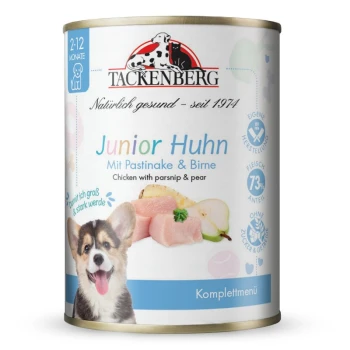 Puszka karmy dla psa Tackenberg Junior Huhn z kurczakiem, pasternakiem, gruszką i szczęśliwym szczeniakiem na etykiecie.