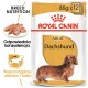 Opakowanie karmy dla dorosłych jamników Royal Canin, z zdjęciem jamnika, z tekstem podkreślającym żywienie rasy i wsparcie stawów.