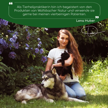 Eine Frau wiegt eine schwarze Katze mit einem Siberian Husky neben ihr, umgeben von lila Blumen und einem Zitat über Wolfsbacher Natur-Haustierprodukte.
