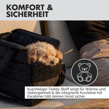 Schwarze gepolsterte Transporttasche für Haustiere mit Teddybär-Symbol und deutschem Text über Komfort- und Sicherheitsmerkmale.
