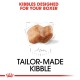 Kibble designed specifically for Boxers, featuring a unique shape and size, with the text "Tailor-Made Kibble" prominently displayed.
