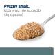 Łyżka kremowej karmy dla zwierząt z tekstem 'Pyszny smak, któremu nie sposób się oprzeć.'