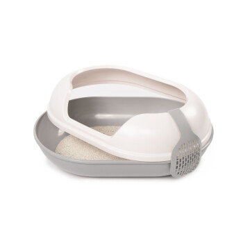 Eine moderne, oval geformte Katzentoilette in sanften Beige- und Grautönen, mit offenem Oberteil und einem angehängten Schaufel mit Schlitzen.