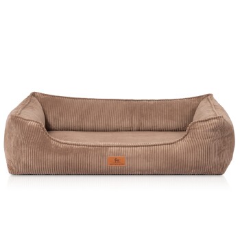 Ein plüschiges, beiges Hundebett mit einem Cord-Textur und erhöhten Kanten, mit einem kleinen Lederetikett, das "KNUFFELWUFF" liest.