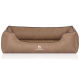 Braunes Hundebett mit einer strukturierten Oberfläche und einem gepolsterten Innenraum, mit dem Logo "KNUFFELWUFF" auf der Vorderseite.