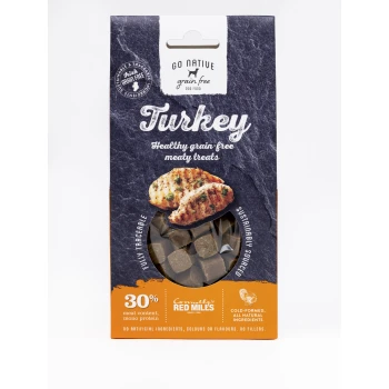 Go Native Turkey grain-free dog treats package with a clear window showing brown cubes and text on 30% meat, mono protein, and sustainability.