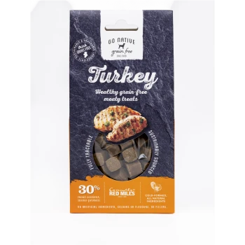 Go Native Turkey grain-free dog treats package with a clear window showing brown cubes and text on 30% meat, mono protein, and sustainability.