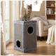 Tabby cat sitting atop tall gray sisal-covered cat condo with two circular openings in a cozy living room.