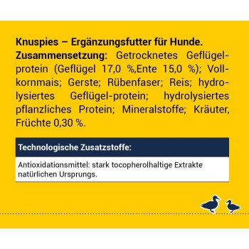 Knuspies-Hundezusatzverpackung mit gelbem Hintergrund, die Zutaten wie Geflügelprotein, Getreide und Früchte auflistet, plus Antioxidantien-Details.
