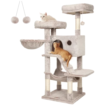 Ein beiger Katzenbaum mit einer weißen Katze, die oben liegt, und einer orangefarbenen Katze, die klettert, mit einer Hängematte, Kratzpfosten und Spielzeugen.